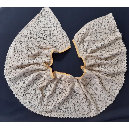 1550 - A 19th century Honiton lace bertha with raised and rolled detail, lined with fine gauze and with one... 