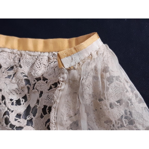 1550 - A 19th century Honiton lace bertha with raised and rolled detail, lined with fine gauze and with one... 