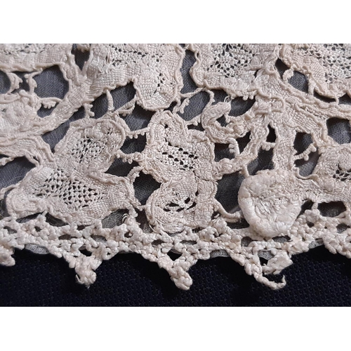 1550 - A 19th century Honiton lace bertha with raised and rolled detail, lined with fine gauze and with one... 
