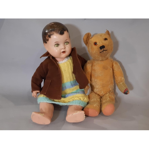 314 - Musical teddy bear, mid 20th century with jointed body, stitched nose and mouth, worn golden plush, ... 