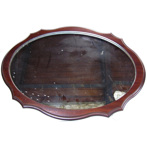 1572 - An angle poise type table lamp in creamy white finish and an oval looking glass within a mahogany wo... 