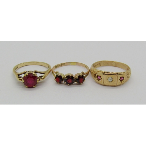 1343 - Three 9ct red gem rings; a topaz solitaire, a garnet three stone example and a spinel and pearl exam... 