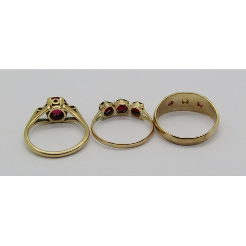 1343 - Three 9ct red gem rings; a topaz solitaire, a garnet three stone example and a spinel and pearl exam... 