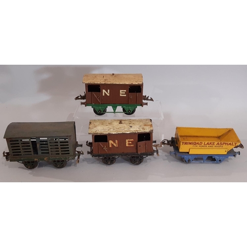 302 - O gauge Hornby railway collection comprising clockwork locomotives, wagons and track; includes 3x 0-... 