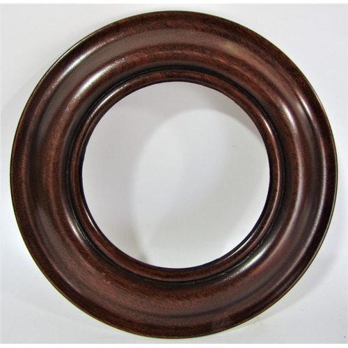 1634 - Five turned and polished circular frames 26cm in diameter max