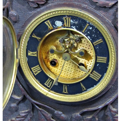 1444 - A Victorian clock movement with eight day striking mechanism and visible escapement, set in a carved... 