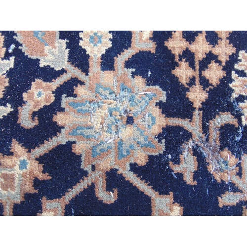 2459 - A Persian design carpet with a large floral pattern on a black ground (as found, moth damage), 235 c... 