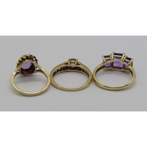 1365 - Three 9ct amethyst rings to include a diamond set example, 7.1g total (3)