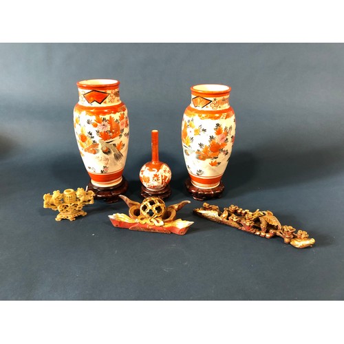 1054 - A pair of Imari baluster vases, 24cm high, another with slender neck, all on stands, a soapstone car... 