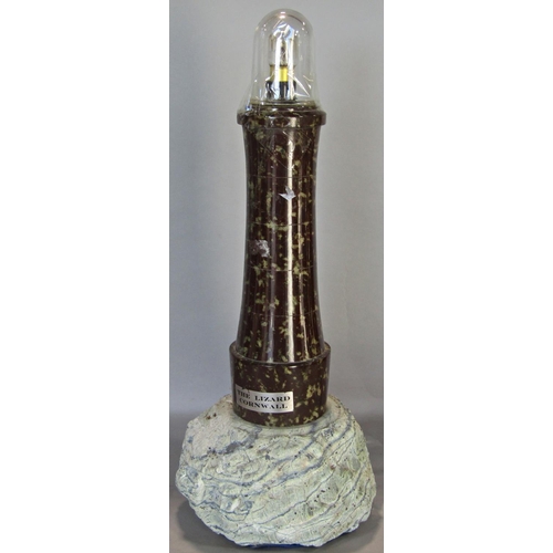 1631 - A Serpentine stone framed aneroid barometer and a further Serpentine stone table lamp in the form of... 