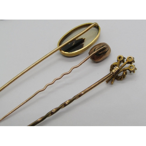 1394 - Three antique yellow metal stick pins to include an example with 15ct head set with three opals, 3.8... 