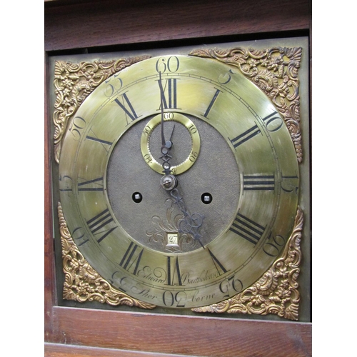 2564 - A Georgian oak longcase clock with column supports enclosing a square brass dial with cast spandrels... 