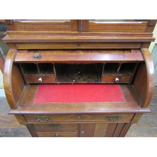 2568 - A small Victorian walnut and figured walnut cylinder top desk, the base enclosed by a single cupboar... 