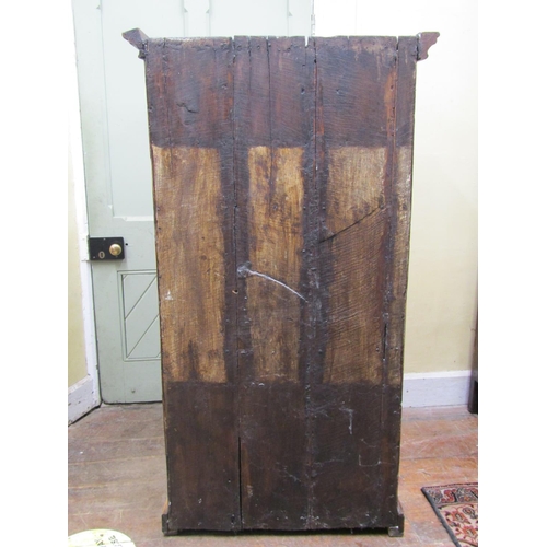 2569 - An Indian hardwood cupboard, enclosed by a pair of panelled doors with iron work fittings, the inter... 