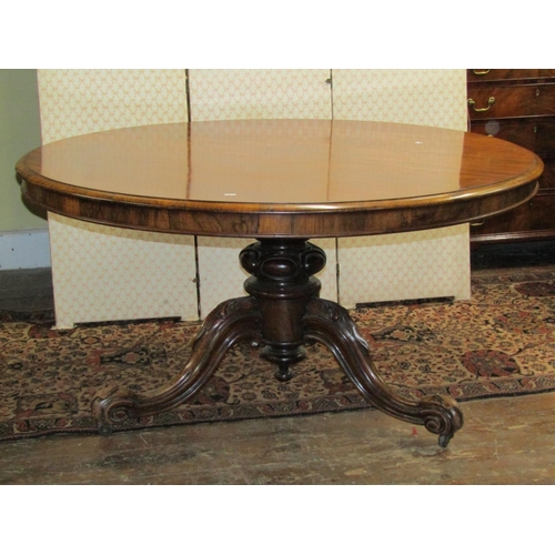 2588 - A Regency rosewood dining table of circular form, raised on a turned and carved column and tripod ba... 