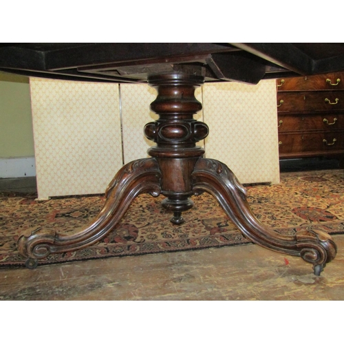 2588 - A Regency rosewood dining table of circular form, raised on a turned and carved column and tripod ba... 