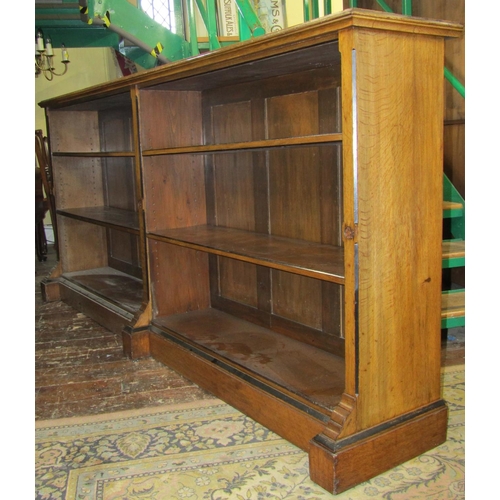 2592 - A Victorian country house open bookcase the pale oak frame with ebonised borders enclosing four adju... 