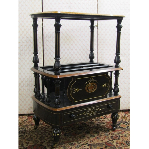 2596 - A Victorian ebonised and gilt lined Canterbury watnot with amboyna wood borders, with two tiers and ... 