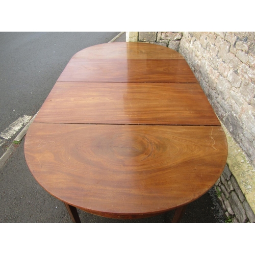 2598 - A Georgian mahogany D end dining table with single additional leaf, D ends supported on tapered legs... 