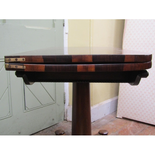 2600 - A Regency foldover top tea table, raised on a cylindrical tapering column and platform base with app... 