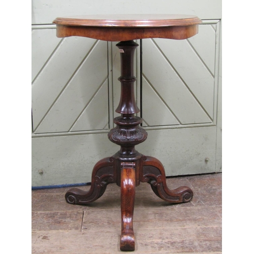 2619 - A Victorian occasional table, the circular figured walnut top with segmented veneers, raised on a ca... 