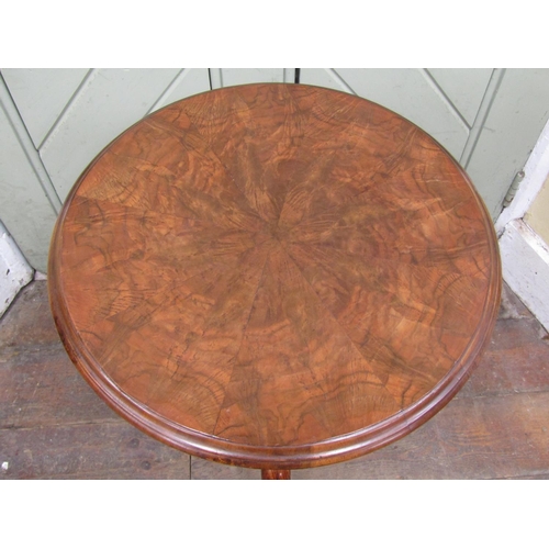 2619 - A Victorian occasional table, the circular figured walnut top with segmented veneers, raised on a ca... 