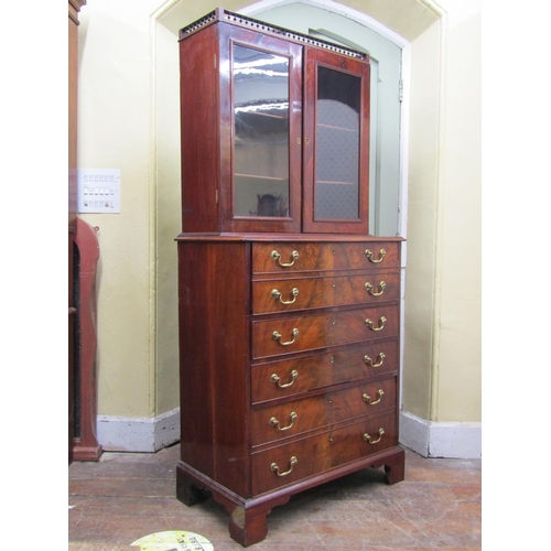 2624 - A small Georgian mahogany secretaire bookcase, the lower section with six drawers, the upper two sec... 