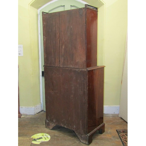 2624 - A small Georgian mahogany secretaire bookcase, the lower section with six drawers, the upper two sec... 