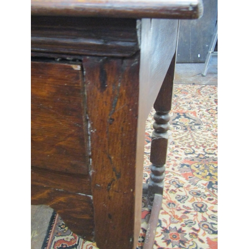 2625 - An antique oak side table with frieze drawer raised on bobbin moulded supports with barley twist rai... 