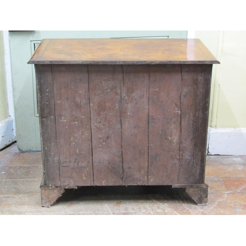 2637 - A Georgian style walnut kneehole writing desk the top quarter panelled, the front enclosing seven dr... 