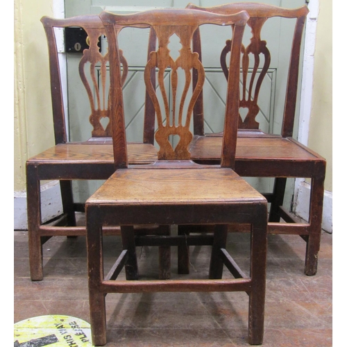 2644 - A set of three Georgian elm countrymade cottage chairs with carved and pierced splats, solid seats a... 