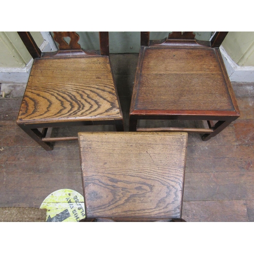 2644 - A set of three Georgian elm countrymade cottage chairs with carved and pierced splats, solid seats a... 