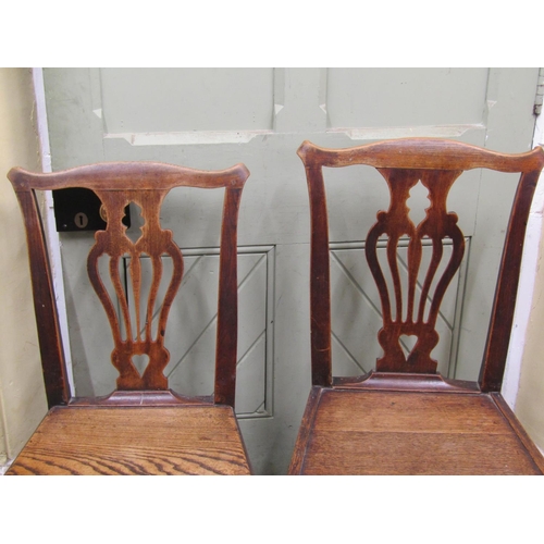 2644 - A set of three Georgian elm countrymade cottage chairs with carved and pierced splats, solid seats a... 