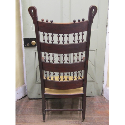 2654 - An arts and crafts bobbin and bar back elbow chair in birch and elm, with embossed leather panels wi... 