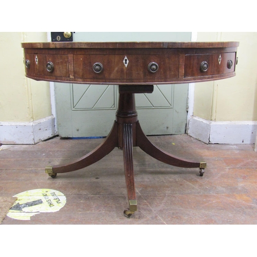 2655 - A Georgian mahogany drum table, the circular top inset with embossed green leather enclosing a serie... 