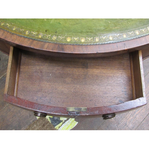 2655 - A Georgian mahogany drum table, the circular top inset with embossed green leather enclosing a serie... 