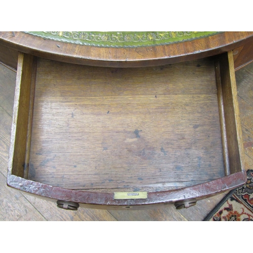 2655 - A Georgian mahogany drum table, the circular top inset with embossed green leather enclosing a serie... 