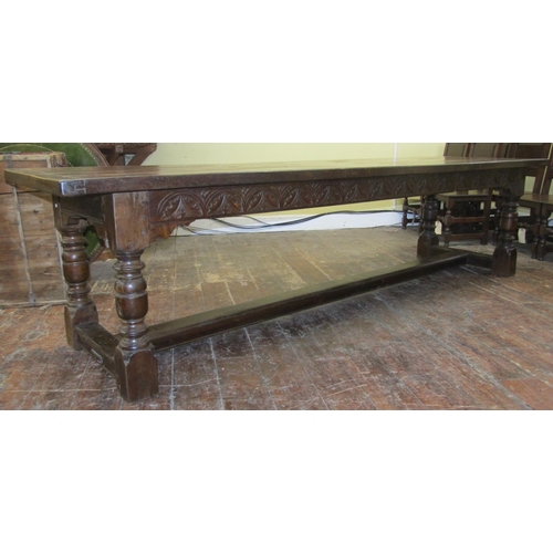 2657 - A good quality old English style oak refectory table to seat ten, the heavy plank top with cleated e... 