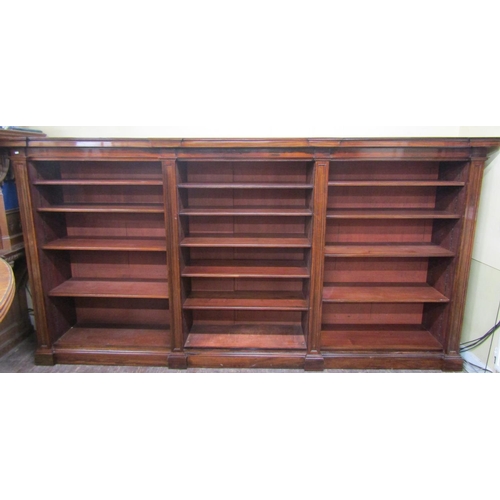 2666 - A fine quality rosewood three divisional bookcase, enclosing thirteen adjustable shelves, within a m... 