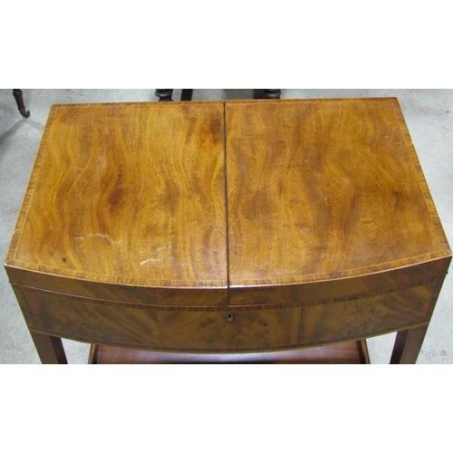 2676 - A Georgian mahogany foldover top dressing table of bowfronted outline, set on four square tapered le... 