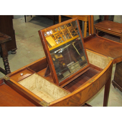 2676 - A Georgian mahogany foldover top dressing table of bowfronted outline, set on four square tapered le... 