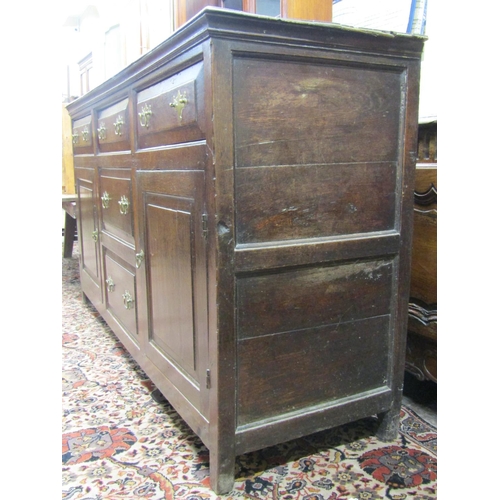 2680 - A Georgian oak dresser base fitted with a T shaped arrangement of five graduated drawers (two dummy)... 