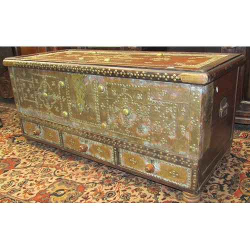 2683 - A Zanzibar hardwood chest with overlaid decorative brass detail with rising lid, over three frieze d... 