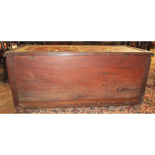 2683 - A Zanzibar hardwood chest with overlaid decorative brass detail with rising lid, over three frieze d... 