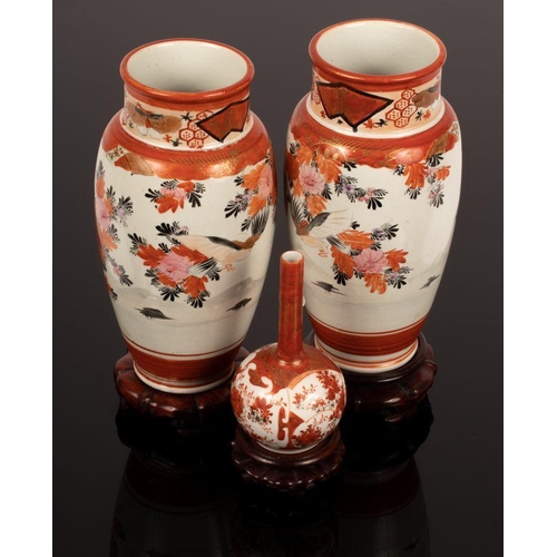 1054 - A pair of Imari baluster vases, 24cm high, another with slender neck, all on stands, a soapstone car... 