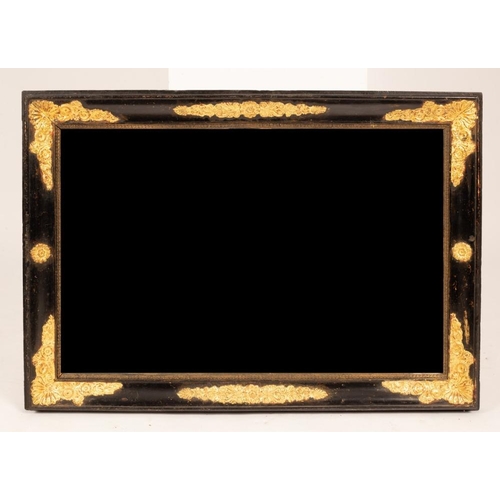 2409 - An ebonised wall mirror with gilded floral spandrels, 48cm x 75cm