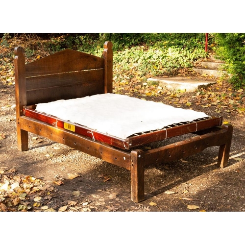 2512 - A Yeoman's early 18th Century oak bed with triangular headboard and poppy type finials to the sides,... 