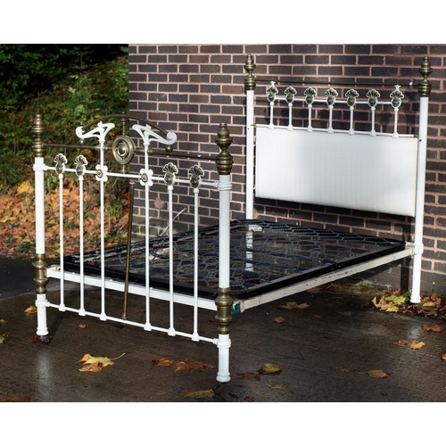 2513 - A Victorian bedstead with brass mounts, the frame later white painted, 142cm wide