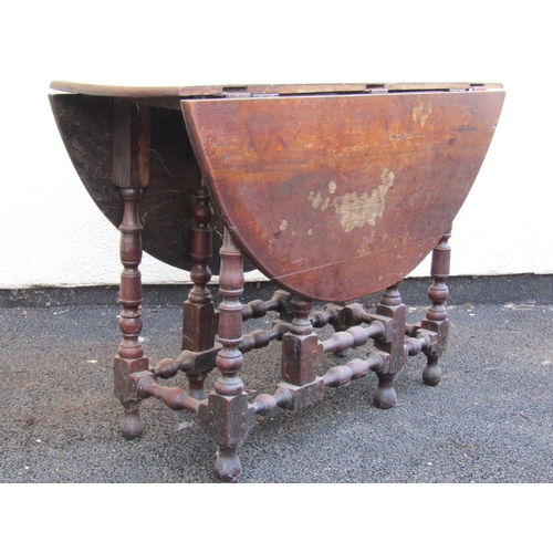 2517 - An 18th century oak gateleg table with well turned legs and supports, 100 cm in length