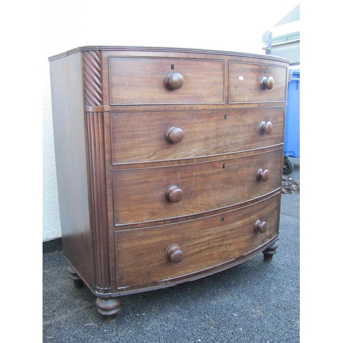 2517A - An early 19th century mahogany bow fronted chest of three long and two short drawers with reeded cor... 